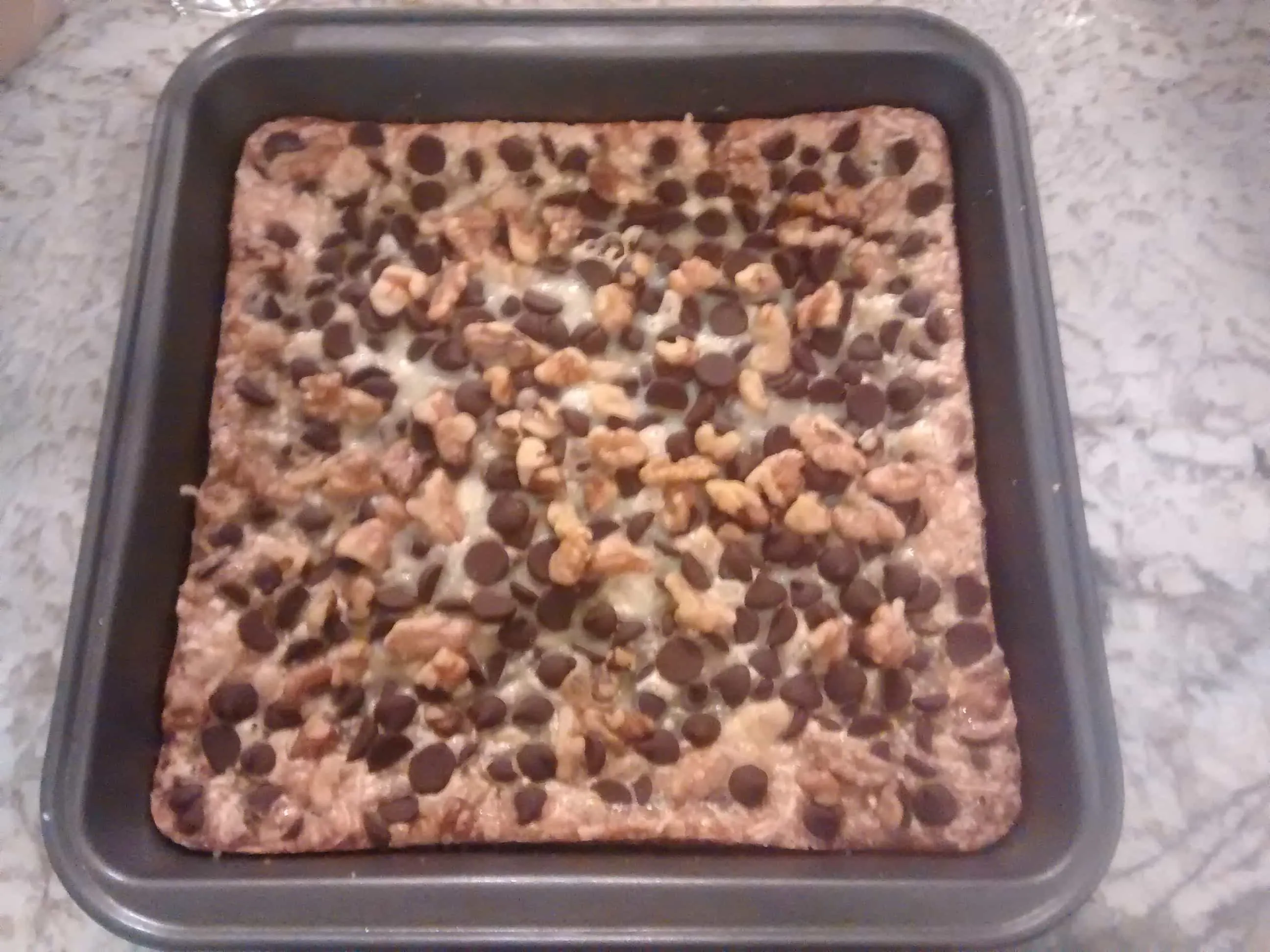 Pan of Magic Bars, sweet and chewy bars covered with coconut and chocolate chips