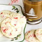 Cake mix cookies on Christmas platter with cup of coffee.