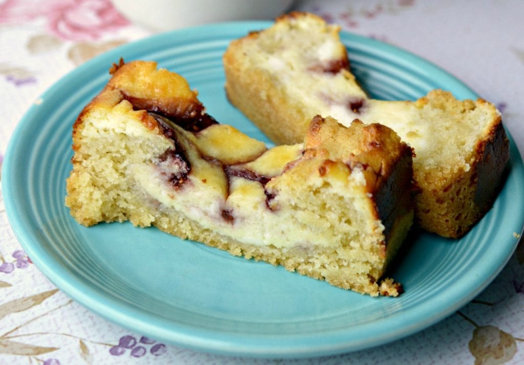 Blue serving dish with 2 slices of Raspberry Cheesecake Swirl Bread