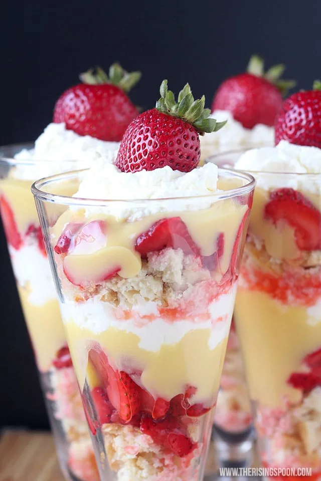 3 Clear glasses of strawberry shortcake lemon curd parfait, topped with fresh strawberries