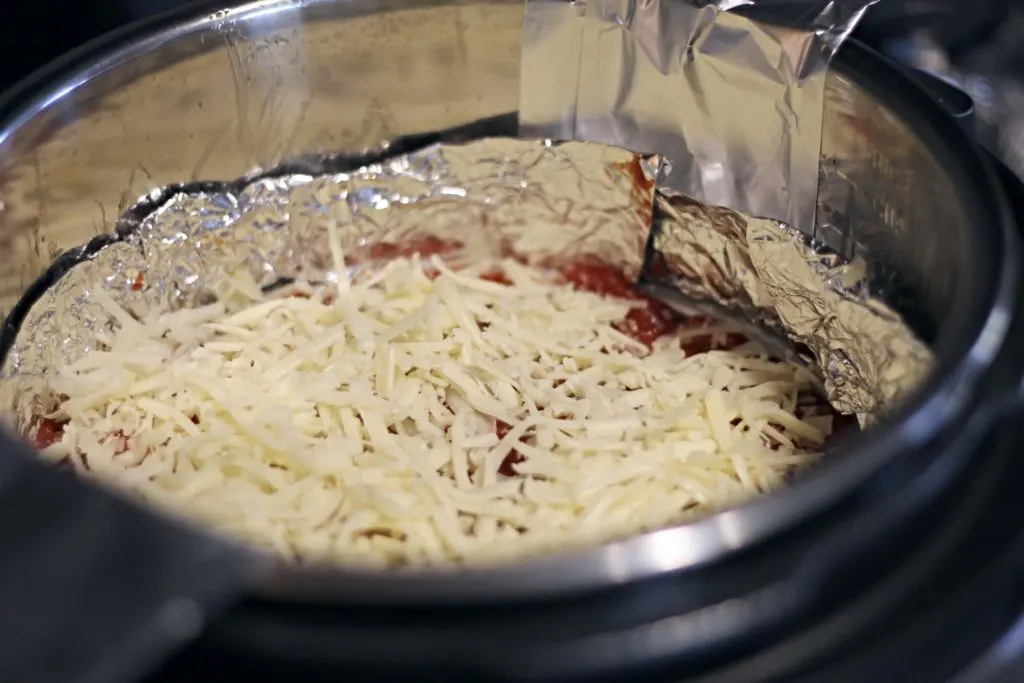 Fold the excess "handles" into the side of the pressure cooker so they are accessible when you are finished cooking to remove the pan.