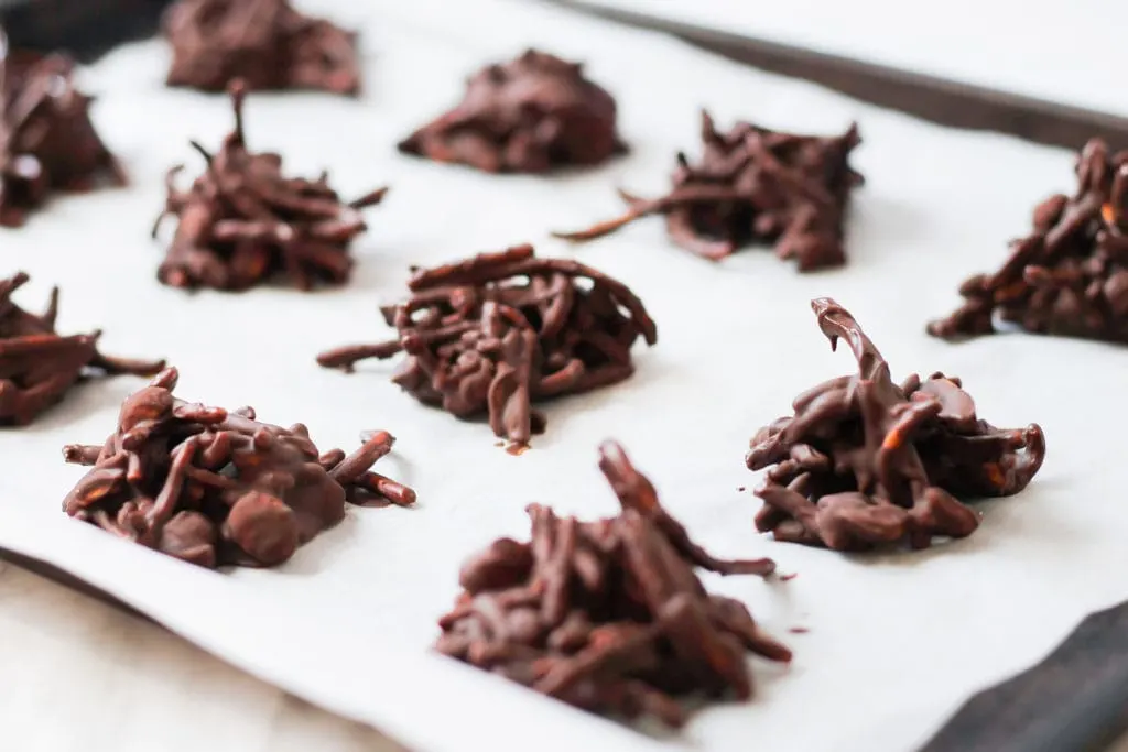 Chocolate Haystack Cookies on baking sheet with parchment paper