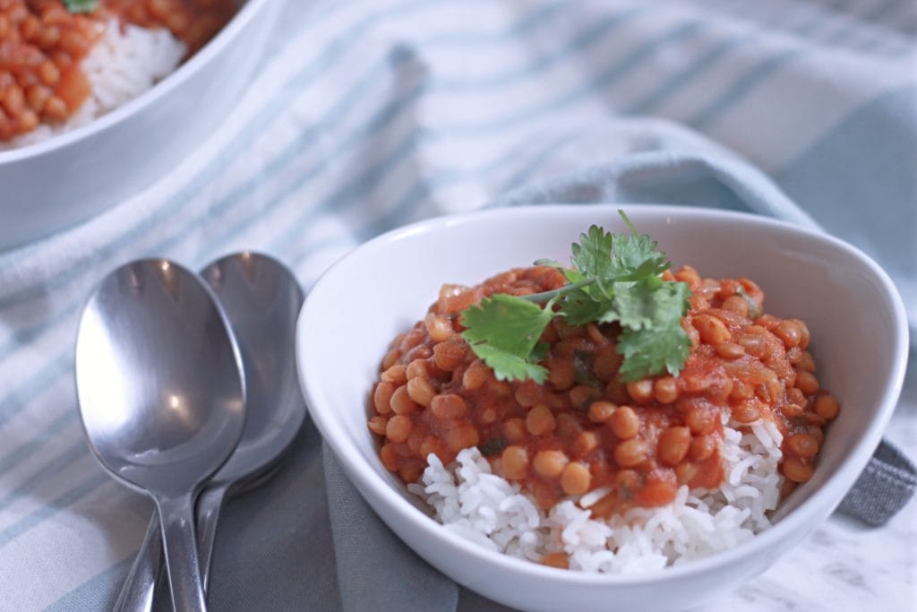 Bowls of Curried Lentils with spoons on a table