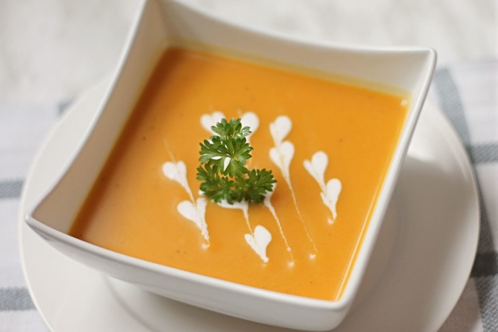 Butternut Squash Soup in white square bowl with garnish