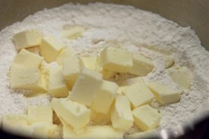 Mixing bowl with flour and cubes of butter.