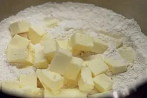 Mixing bowl with flour and cubes of butter.