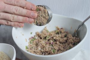 pressing tuna mixture to form a fish cake 