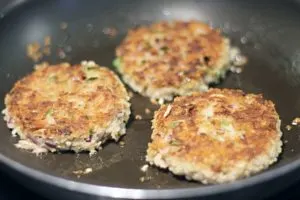 golden cooked tuna cakes in frying pan 