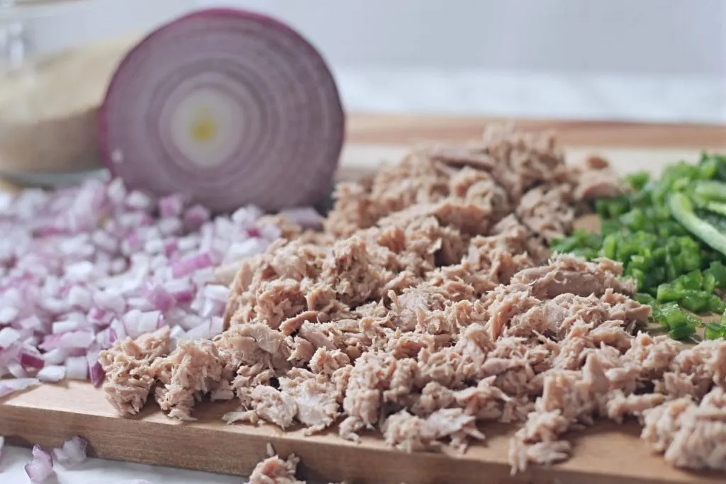 ingredients for tuna cakes on cutting board