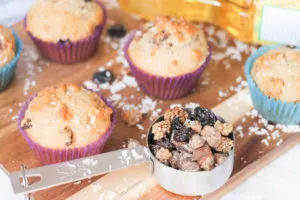 Mixed Berry Muffins with shredded coconut and dried fruit in measuring cup