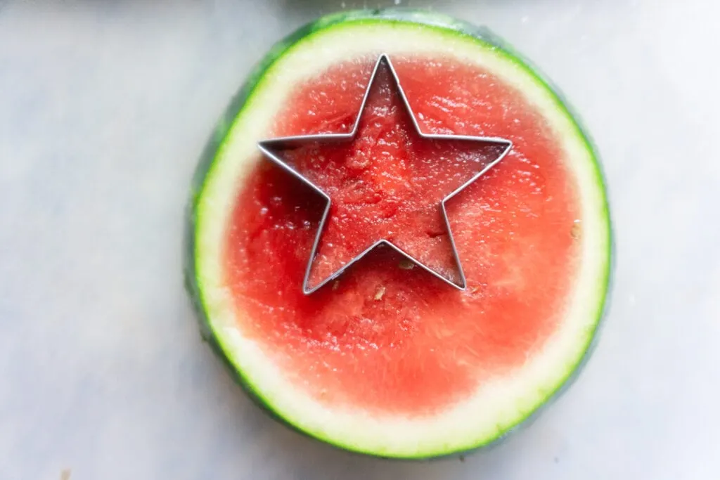 round slice of watermelon with star shaped cookie cutter.